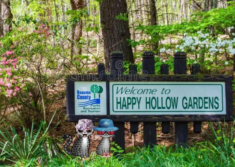 Periwinkle Stinky Happy Hollow Two cartoon tabby cats wearing sun hats in front of a sign that reads: Happy Hollow Gardens.