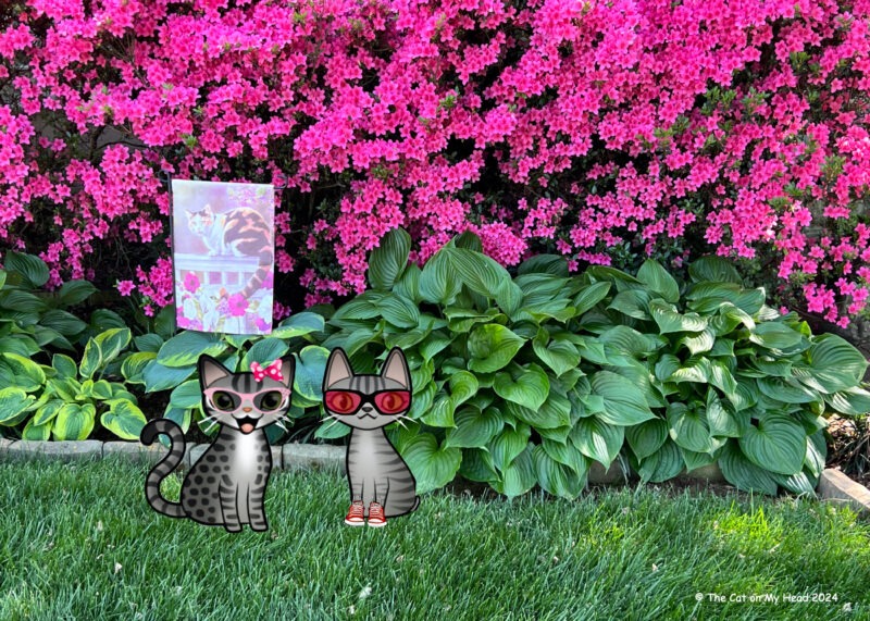 Periwinkle Stinky Happy Hollow Two cartoon tabby cats standing in front of dark pink azalea bushes and hostas and a garden flag with a calico cat.