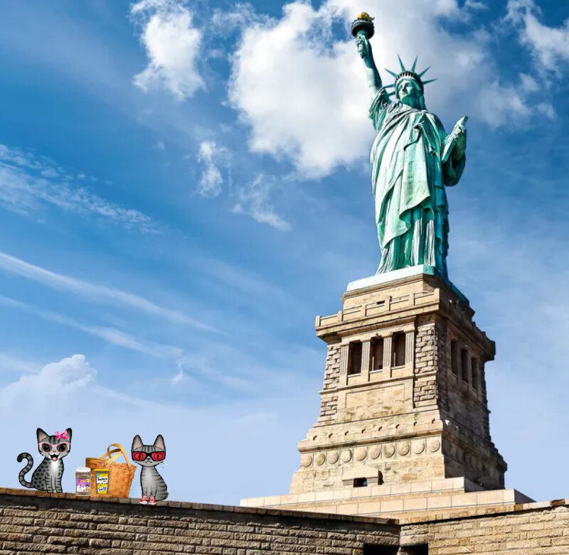 Stinky Periwinkle Statue of Liberty: Two cartoon tabby cats having a picnic at the base of the Statue of Liberty.
