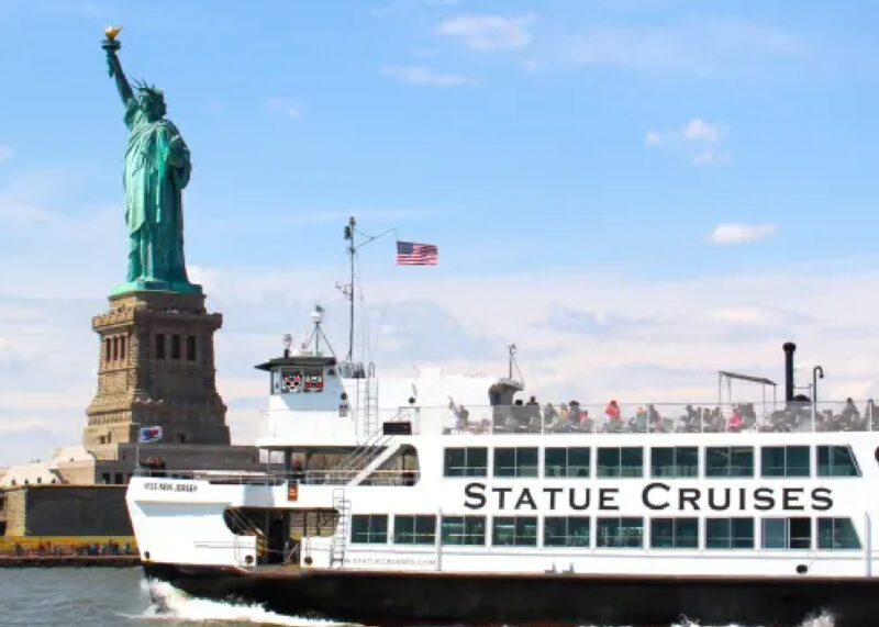 Stinky Periwinkle Statue of Liberty: Two cartoon tabby cats on the Statue of Liberty ferry with the statue in the background.