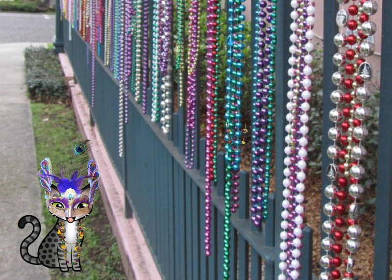 Periwinkle Stinky Mardi Gras Grey cartoon tabby cat in a Mardi Gras mask next to a fence covered in Mardi Gras beads.