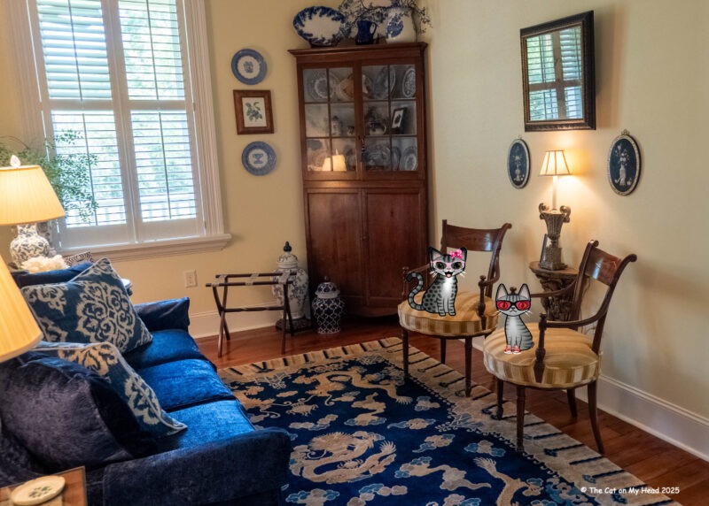 Two cartoon tabbies cats, Periwinkle Stinky, in the sitting room of the Blueberry Suite at The Lemon Hotel.