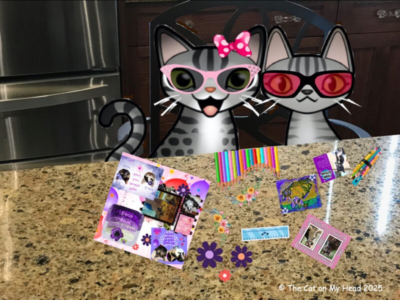 Periwinkle Stinky birthday two cartoon tabby cats sitting at a kitchen counter with items to create scrapbook pages.