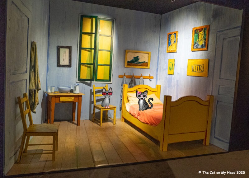 Van Gogh Experience A reproduction of Van Gogh's bedroom with two cartoon tabby cats from the Van Gogh Immersive Experience.