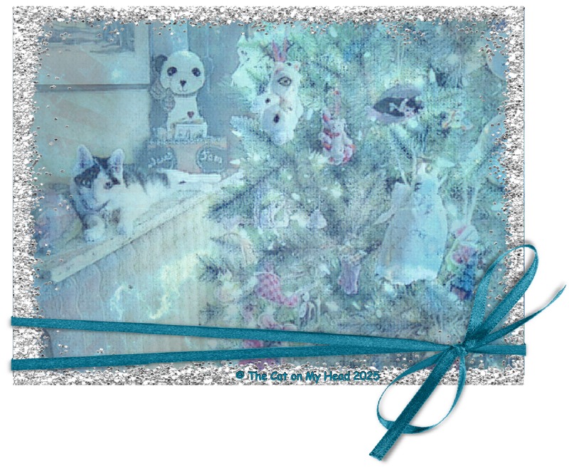 kitten winter art A tuxie cat on a radiator next to a Christmas Tree which has been turned into a winter scene with a sparkly silver frame and teal bow.