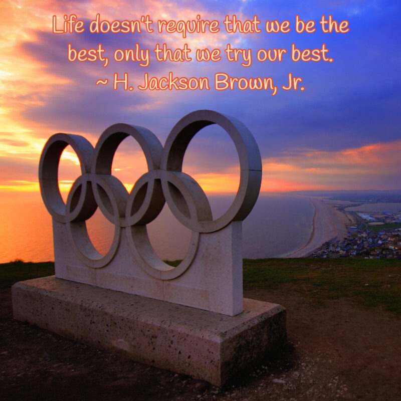 A photo of a sunset with a statue of the Olympic Rings with the following quote from H. Jackson Brown, Jr., "Life doesn’t require that we be the best, only that we try our best."
