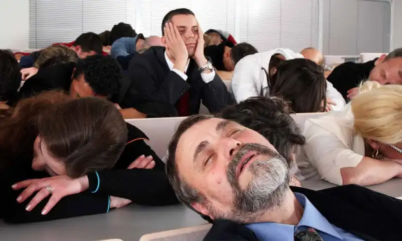 All but one person sound asleep at a lecture.