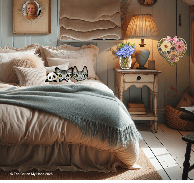 Two cartoon tabby cats snuggled together in bed.